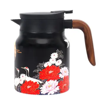 An outside view of the tea kettle. It is black with Asian-influenced artwork depicting Sandhill cranes among red and white peony flowers. The lid of the kettle is black and the handle is natural wood.