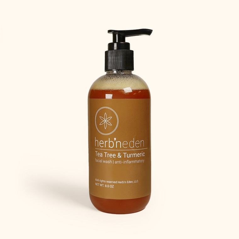 An image of the product. The bottle has a pump handle, and is rounded near the top and bottom. The facial wash inside is a warm amber color.