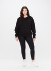 THE UPSIDE women's black Saturn Arrow Sweater is an organic cotton fleece jumper with a relaxed, oversized fit. It features a soft rib at the neckline, handcuffs and cuffs.