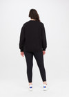 THE UPSIDE women's black Saturn Arrow Sweater is an organic cotton fleece jumper with a relaxed, oversized fit. It features a soft rib at the neckline, handcuffs and cuffs.