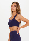 THE UPSIDE women's navy blue Peached Jade Bra is a sustainable scoop neck, full coverage T-back bra with internal elastic in the underbust and removable cups.
