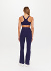 THE UPSIDE Peached Florence Flare in Navy is a sustainable high-rise full length flare pant with “V” waistband detail and printed arrow logo at back waistband.