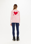 THE UPSIDE Alpine Chrissy Knit Top in Striped Red and White is a sustainable lightweight knit top with vertical stripe design, mini frill detail at cuff and intarsia heart and arrow at back.