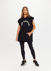 THE UPSIDE Recovery Hoodie in Black is an organic cotton sleeveless, longline hoodie with a cream horseshoe logo print at centre front and raw edges with kangaroo pocket and drawcord through hood.