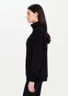 THE UPSIDE Jerome Half Zip Crew in Black is a sustainable organic cotton oversized half zip crew with a soft rib hem and cuffs and kangaroo pocket