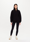 THE UPSIDE Jerome Half Zip Crew in Black is a sustainable organic cotton oversized half zip crew with a soft rib hem and cuffs and kangaroo pocket