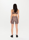 THE UPSIDE Ryker 6inch Spin Short in Leopard print is a sustainable mid-rise 6inch length spin short with contrast printed arrow at centre back and striped elastic down sides.