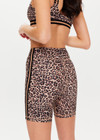 THE UPSIDE Ryker 6inch Spin Short in Leopard print is a sustainable mid-rise 6inch length spin short with contrast printed arrow at centre back and striped elastic down sides.