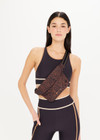 THE UPSIDE Malo Belt Bag in Leopard print is a recycled belt bag with a striped adjustable strap, magnetic snap button closure and pockets.