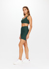 THE UPSIDE Peached 6inch Pocket Spin Short in Dark Green is a recycled mid-rise 6” spin short with pockets and printed arrow at centre back.