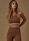 THE UPSIDE women’s brown Form Seamless Angie Crop made with Form Seamless fabric features a high neck-line, white contrast stripe on under-bust, elasticated straps and removable cups.