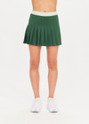 THE UPSIDE Oxford Sloan Skirt in Fern Green is a sustainable pleated tennis skirt with inner shorts, pockets and elastic mint green waistband.