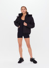 THE UPSIDE women's black Peached Jamie Onesie is a recycled all-in-one 3” onesie with adjustable straps, removable cups and pockets.