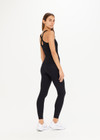 THE UPSIDE women's black, form-fitting Balance Seamless Lenny Tank is made from fabric with moisture control properties and is designed for a soft and supportive fit. This tank top features a scoop neck, cross back straps and shelf bra and bra cups for support.