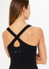 THE UPSIDE women's black, form-fitting Balance Seamless Lenny Tank is made from fabric with moisture control properties and is designed for a soft and supportive fit. This tank top features a scoop neck, cross back straps and shelf bra and bra cups for support.