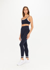 THE UPSIDE womens navy Form Seamless 25in Midi Pant made with Form Seamless fabric features contrast white stripe on ankles, soft ribbed waistband and 25-inch length leg.