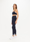 THE UPSIDE womens navy Form Seamless 25in Midi Pant made with Form Seamless fabric features contrast white stripe on ankles, soft ribbed waistband and 25-inch length leg.
