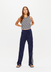 THE UPSIDE womens navy mid rise Celeste Pant made with slinky fabrication features a relaxed straight leg silhouette, elasticated waistband, drawcord, and white stripe down side seams.