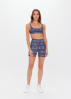 THE UPSIDE women’s mid-rise indigo Yukimi 5 Inch Pocket Spin Short made with Recycled Rib fabric features an abstract print, side pockets and moisture wicking properties; perfect for yoga, pilates or barre.