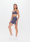 THE UPSIDE women’s mid-rise indigo Yukimi 5 Inch Pocket Spin Short made with Recycled Rib fabric features an abstract print, side pockets and moisture wicking properties; perfect for yoga, pilates or barre.