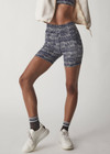 THE UPSIDE women’s mid-rise indigo Yukimi 5 Inch Pocket Spin Short made with Recycled Rib fabric features an abstract print, side pockets and moisture wicking properties; perfect for yoga, pilates or barre.