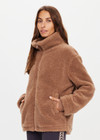 THE UPSIDE women's brown oversized Hudson Jacket made with faux shearling features a high neck collar with zipper, drawcord at waist and pockets. Fully lined, designed for winter.