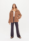 THE UPSIDE women's brown oversized Hudson Jacket made with faux shearling features a high neck collar with zipper, drawcord at waist and pockets. Fully lined, designed for winter.