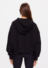 THE UPSIDE women's black Jude Crop Hoodie is made from an organic cotton loopback fabrication. This oversized hoodie has a relaxed zip through shape, is hooded with drawcords and metal aglet ends and features ribbed cuffs and hemband.