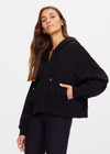 THE UPSIDE women's black Jude Crop Hoodie is made from an organic cotton loopback fabrication. This oversized hoodie has a relaxed zip through shape, is hooded with drawcords and metal aglet ends and features ribbed cuffs and hemband.