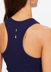THE UPSIDE women's navy Sophie Crop made in organic cotton rib features a cropped racer back, built-in shelf bra with removable cups and an embroidered arrow at centre back; everyday luxe.