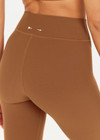 THE UPSIDE women's women's brown tobacco mid rise 25inch midi legging is made from recycled soft peach with moisture wicking, breathable and quick drying properties.