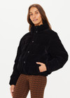 THE UPSIDE women's jet-black Amari Puffer Jacket made in plush velvet fabrication features full lining with an internal zip pocket, elasticated cuffs, adjustable cord at hem, front welt pockets, zip front with snap button closure, and an embossed horseshoe logo apple leather patch.
