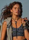 THE UPSIDE women's mid-coverage indigo paisley pattern Nouveaux Candice Crop made in Recycled Soft Peached features a long-line fit, subtle panelling, printed arrow logo at back and moisture wicking properties.