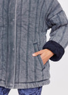 THE UPSIDE women's denim-blue Nouveaux Daria Jacket made with organic cotton jersey fabrication is an oversized zip-through quilted jacket featuring twin needle stitch detailing, snap buttons and printed indigo paisley lining.