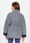 THE UPSIDE women's denim-blue Nouveaux Daria Jacket made with organic cotton jersey fabrication is an oversized zip-through quilted jacket featuring twin needle stitch detailing, snap buttons and printed indigo paisley lining.