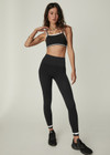 THE UPSIDE women's black mid-rise 25inch legging is made from our form seamless fabric with moisture control properties. It features a soft ribbed waistband and white stripe.