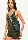 THE UPSIDE women's green Cosette Crosbody Bag is made with recycled fabric. This crossbody features a front slip pocket, a larger compartment, and an adjustable strap.