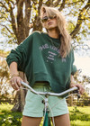 THE UPSIDE women's green Jetset Paloma Crew is made with organic cotton for an oversized fit. This boxy crew features ribbed neck cuffs and hem, and a drop shoulder relaxed style.