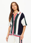 THE UPSIDE women's white, red, navy and green Reverie Chino Shirt is made with organic cotton for a true to size fit. This relaxed button through features a ribbed collar and hem.