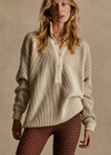 THE UPSIDE women's natural Alana Knitted Sweater is made with organic knit cotton, for an oversized fit. This knitted polo features a button front, and ribbed knit hem and cuffs.