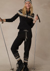 THE UPSIDE women’s black Fairbanks Jojo Knit Jogger is made from organic cotton. The cuffed pants features side pockets and soft knitted waistband. Designed for Après-ski and winterwear.