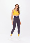 THE UPSIDE women's yellow Dunes 25 inch Midi Pant is made from recycled textured rib fabrication with moisture wicking properties. The mid-rise pant is styled with navy and yellow for style and an elasticated drawcord through the waist for the perfect fit. Designed for the gym.