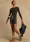THE UPSIDE women's grey Dunes 5 inch Spin Short is made from recycled textured rib fabrication with moisture wicking properties. The mid-rise spin short are styled with yellow side stripes and drawcord through the waist. Designed for the gym.