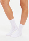 THE UPSIDE women's white Lavalliere Sock is made in breathable cotton. The crew sock is designed with jacquard arrow on the sole and navy satin bows at the edges. Designed for all types of movement.