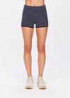 THE UPSIDE women's navy Caleta 3 inch Spin Short is made with gold lurex, a speciality fabric. The mid rise spin short is framed in navy ribbed binds with a speciality curved leg line. Designed for yoga, pilates and walking.