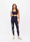 THE UPSIDE women's navy Cordoba 25 inch Midi Pant is made from a eco tech performance fabric making the pant breathable and quick drying. The mid rise pant features a printed white stripe down the leg creating a sporty chic look. Designed for the gym and running.