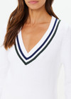 THE UPSIDE women's white Sonny V Neck Knit Sweater is made from organic cotton. The classic V neck knit features a navy and green stripe at the neck and sleeve for an elevated finish. Designed for leisure and recovery.