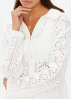 THE UPSIDE women's white Lavalliere Malia Knit Shirt is made from organic cotton. The long sleeve knit shirt features an open lace knit construction with bow knitted detailing and fitted with buttons and a ribbed collar. Designed leisure and recovery.