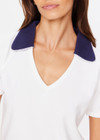 THE UPSIDE women's white Jacobs V Neck Collared Polo is made from organic cotton. The slim fit white polo is contrasted with navy and a rounded collar. Designed for golf.