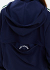 THE UPSIDE women's navy Mansi Dawson Run Jacket is made in a light and breathable recycled fabric, featuring colours of green and white. The run jacket is water resistant and is fitted with elasticated cuffs with inner sleeve gloves and invisible zip pockets and a large back pocket for storing purposes. Designed for golf.